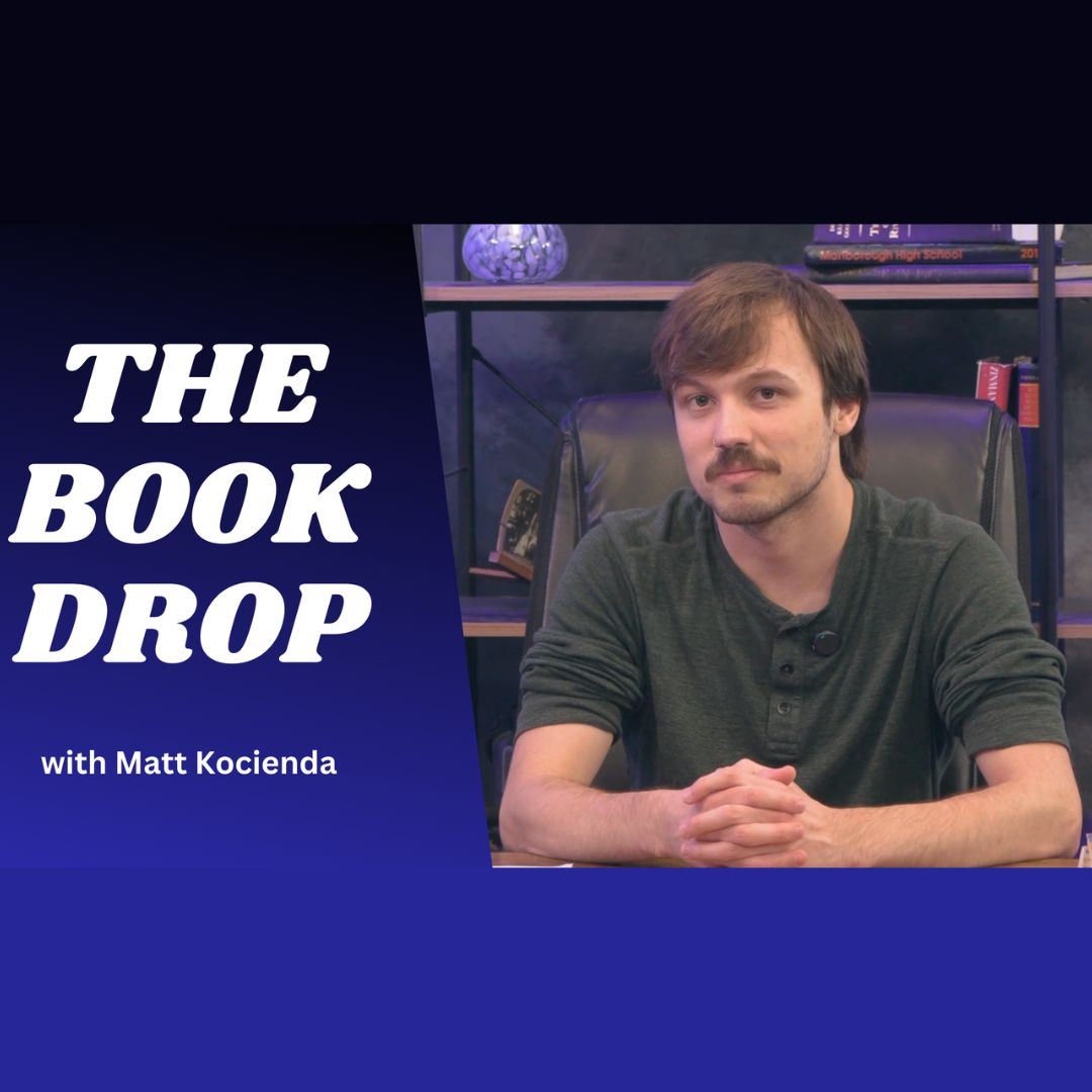 Man sitting at desk looking into camera